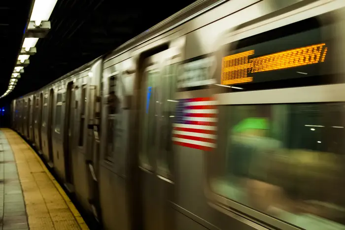 An E train in motion, with the photo blurred.
